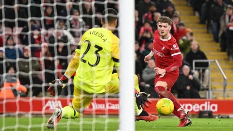 Gelandang Liverpool, Harvey Elliot dipeluk sang manajer, Arne Slot. Elliot mencetak gol kemenangan Liverpool atas PSG pada leg pertama 16 besar Liga Champions 2024/2025 di Parc des Princes, P