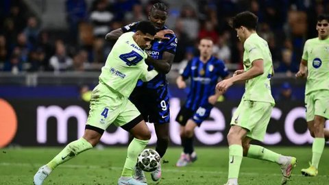 Bek Barcelona asal Uruguay #04, Ronald Federico Araujo da Silva (kiri), dan penyerang Inter Milan asal Iran #99, Mehdi Taremi, berebut bola selama pertandingan leg kedua semifinal Liga Cha