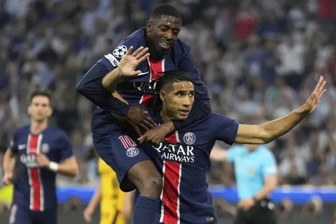 Pemain PSG Achraf Hakimi merayakan gol bersama rekannya Desire Doue dalam laga final Liga Champions melawan Inter Milan di Allianz Arena, Minggu, 1 Juni 2025. (AP Photo/Luca Bruno)