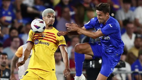 Pemain Barcelona, Ronald Araujo (kiri) berebut bola dengan pemain Getafe, Juanmi Latasa pada laga pekan pertama Liga Spanyol 2023/2024 di Coliseum Alfonso Perez Stadium, Getafe, Spanyol, 14
