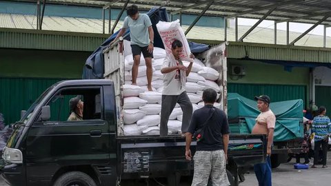 Pedagang melihat beras dagangannya di Pasar Induk Cipinang, Jakarta, Senin (25/9). Pedagang beras Cipinang sudah menerapkan dan menyediakan beras medium dan beras premium sesuai harga eceran
