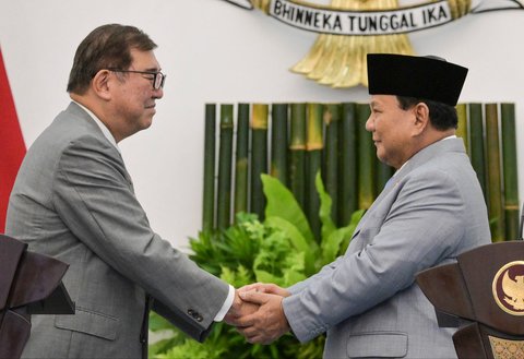 Presiden Indonesia Prabowo Subianto bersama  Perdana Menteri Jepang Shigeru Ishiba berjabat tangan usai memberikan pernyataan pers setelah pertemuan mereka di istana presiden di Bogor, Jawa Barat.