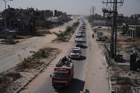 Ambulans mengangkut jenazah warga Palestina tak dikenal yang dipulangkan dari Israel ke lokasi pemakaman massal di Deir al Balah, Jalur Gaza, Rabu (22/10/2025).