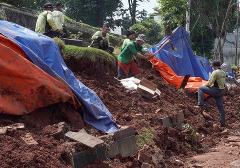 Petugas Sudin Kehutanan DKI melakukan perbaikan tembok pembatas yang roboh di Tempat Pemakaman Umum (TPU) Jeruk Purut, Jakarta Selatan, Kamis (30/10/2025).