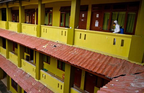 Petugas Badan Penanggulangan Bencana Daerah menyemprotkan cairan disinfektan di ruangan asrama putra Sekolah Menengah Negeri 19, Banda Aceh, Aceh, Jumat (31/10/2025).