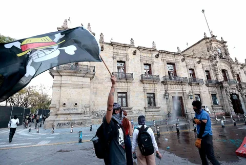 Seorang demonstran mengibarkan bendera One Piece saat bentrokan menentang pemerintahan Presiden Meksiko Claudia Sheinbaum di Guadalajara, Meksiko, Sabtu (15/11/2025).