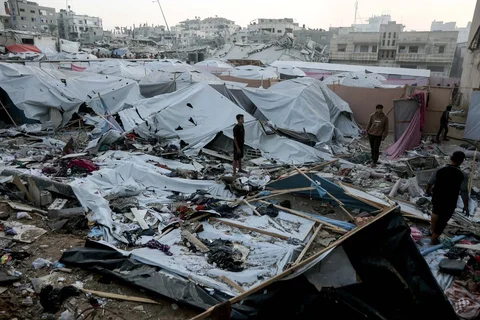 Warga Palestina terlihat mengamati area pengungsi yang hancur setelah serangan militer Israel di Kota Gaza Sabtu (22/11/2025).