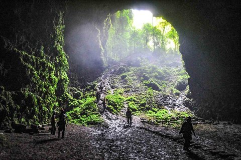 Pengunjung berada di mulut Goa Jpmblang  di Gunung Kidul, Yogyakarta.