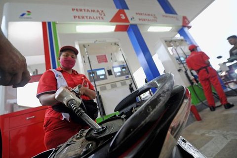 Pengendara motor mengisi kendaraannya dengan BBM di salah satu SPBU, Jakarta, Selasa (15/3). Pertamina menurunkan harga bahan bakar minyak (BBM) umum Pertamax, Pertamax Plus, Pertamina Dex, d