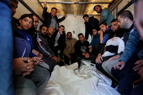 Para pelayat berdiri di sisi jenazah anggota keluarga Al-Nader yang dilaporkan tewas sehari sebelumnya akibat serangan Israel terhadap sekolah yang dijadikan tempat perlindungan di kawasan Tuffah, Kota Gaza, Sabtu (20/12/2025).