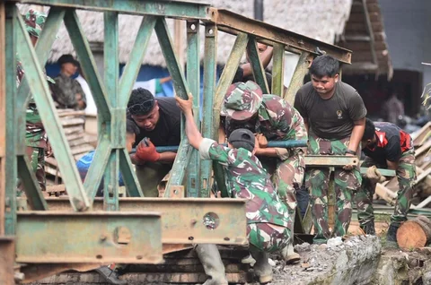 Prajurit TNI AD bekerja memasang Jembatan Bailey di Desa Cot Bada, Kabupaten Bireuen, Jumat (19/12/2025) guna memulihkan akses transportasi masyarakat yang terputus akibat banjir dan tanah longsor.