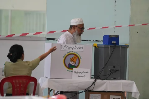 Seorang pemilih memberikan suara di tempat pemungutan suara pada hari Minggu (28/12/2025) di Yangon, Myanmar.