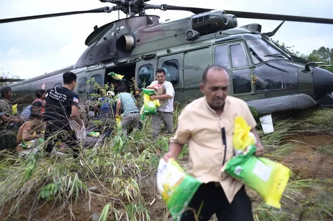 Warga saat mendapatkan  bantuan kemanusiaan di daerah terdampak banjir di Aceh Tengah, Indonesia, Sabtu (06/12/2025).