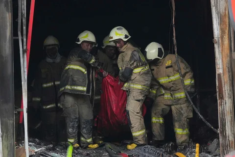 Petugas pemadam kebakaran mengevakuasi jenasah korban  kebakaran di gedung perkantoran Terra Drone di Jalan Letjen Suprapto, Cempaka Baru, Kemayoran, Jakarta Pusat Selasa (09/12/2025)..