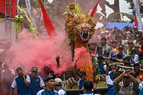 Warga mengarak durian dan buah-buahan lainnya saat festival durian "Kenduren Wonosalam" di desa Wonosalam, Jombang,  Jawa Timur, (23/ 02/ 2025).
