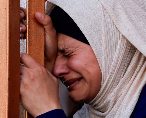 Warga menangis saat pemakaman anak-anak warga Palestina yang tewas dalam serangan Israel, di rumah sakit Nasser, di Khan Younis, Jalur Gaza Selatan, Minggu (11/05/2025).