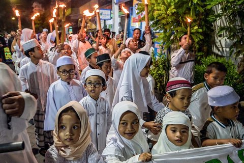 Anak-anak mengikuti pawai obor menandai dimulainya Tahun Baru Islam 1 Muharram 1447 Hijriah di Surabaya, (26/06/2025).