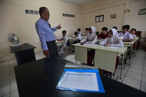 Murid tingkat SMP  dalam program Rintisan Sekolah Swasta Gratis belajar dalam kelas saat kegiatan MPLS (Masa Pengenalan Lingkungan Sekolah) di SMP Tarbiyah Islamiyah, Depok, Jawa Barat, Senin (14/07/2025).