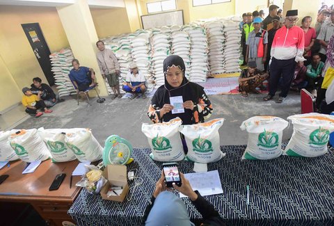 Keluarga Penerima Bantuan Pangan (PBP)  antri untuk menerima Bantuan Pangan Non Tunai (BPNT)  beras 20 kg di Kantor Kelurahan Rangkapan Jaya Baru, Depok, Jawa Barat, Kamis, (24/07/2025)