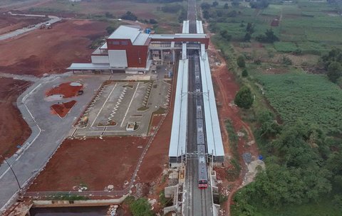 Foto udara rangkaian kereta rel listrik (KRL) Commuterline melintas di samping proyek pembangunan Stasiun Jatake, Pagedangan, Kabupaten Tangerang, Banten, Selasa (29/7/2025).