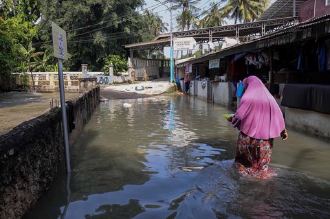 Aktivitas warga saat banjir merendam pemukiman di kawasan Kampung Makasar, Jakarta Timur, Senin (07/07/2025).
