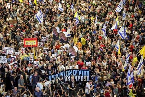 Para pengunjuk rasa berkumpul dalam demonstrasi yang diselenggarakan oleh keluarga para sandera Israel yang ditawan di Jalur Gaza di luar kantor pusat Kementerian Pertahanan di Tel Aviv, Israel, Sabtu (09/08/2025) malam.