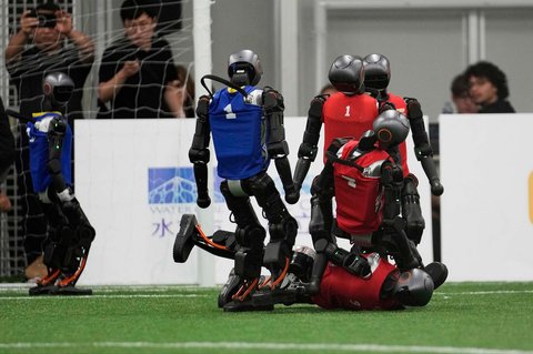 Robot humanoid saat bermain sepak bola dalam pertandingan eksibisi menjelang World Humanoid Robot Games 2025 yang dijadwalkan mulai 14 hingga 17 Agustus di Beijing, Tiongkok, Senin (04/08/2025).