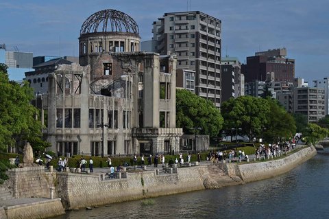 Pengunjung berjalan melewati Kubah Bom Atom pada malam peringatan 80 tahun serangan bom atom pertama di kota Hiroshima, Jepang, Selasa (05/08/2025).