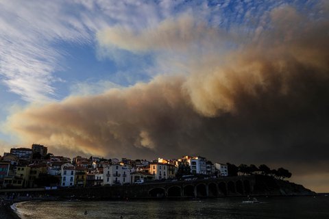 Asap dari kebakaran hutan yang berkobar di departemen Aude terlihat dari pesisir Mediterania di Banyuls-sur-Mer, Prancis barat daya, Selasa (05/08/2025) waktu setempat.