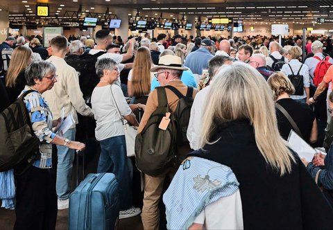 Calon penumpang berkumpul setelah serangan siber yang menyebabkan keterlambatan penerbangan di Bandara Internasional Brussels di Zaventem, Sabtu (20/9/2025).