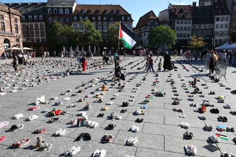 Sepatu-sepatu dibentangkan sebagai aksi simbolis mengenang puluhan ribu warga Palestina yang tewas dalam serangan Israel di Gaza di Place Kleber, Strasbourg, Prancis, Sabtu (20/9/2025).