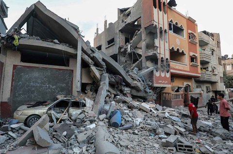 Warga Palestina memeriksa puing-puing bangunan yang terkena serangan Israel di kamp pengungsi Nuseirat di Jalur Gaza tengah, Kamis (25/09/2025).
