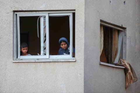 Warga Palestina melihat reruntuhan bangunan di dekat kamp pengungsi Nuseirat yang terkena serangan Israel di Jalur Gaza tengah, Kamis (25/09/2025).
