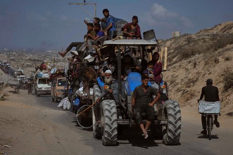 Warga Palestina yang mengungsi dari Gaza utara membawa barang-barang mereka di sepanjang jalan pesisir menuju Gaza selatan, Selasa (09/09/2025).