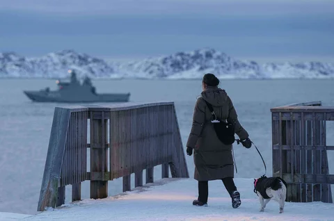 Seorang wanita berjalan bersama anjingnya di Nuuk, Greenland, pada hari Kamis(15/01/2026) waktu setempat.
