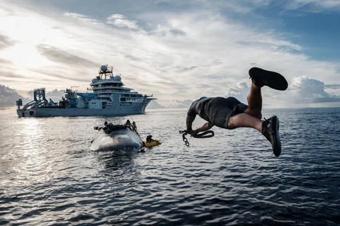 Awak kapal OceanXplorer, sebuah kapal penelitian yang dioperasikan oleh organisasi nirlaba kelautan OceanX, melompat ke laut menuju kapal selam yang muncul ke permukaan dan memasang tali penyelamat di perairan lepas pantai Pulau Sulawesi, Jumat (09/01/2026).