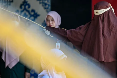 Seorang wanita yang dituduh melakukan hubungan seks di luar nikah dicambuk di depan umum oleh anggota polisi Syariah di Banda Aceh, Kamis (29/01/2026).