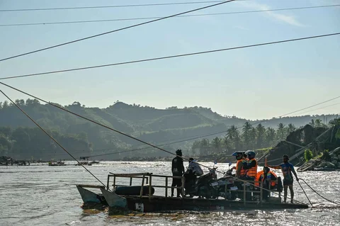 Warga menggunakan rakit  untuk menyeberangi sungai Peusangan di Ulee Jalan, Peusangan Selatan, Bireuen, Aceh, Senin (05/01/2026).