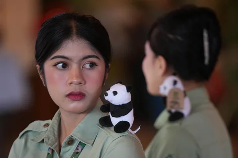 Para staf mengenakan boneka panda di bahu mereka selama konferensi pers yang mengumumkan kelahiran anak panda raksasa pertama di Indonesia, di Taman Safari Indonesia, Cisarua, Bogor, Selasa (06/01/2026).