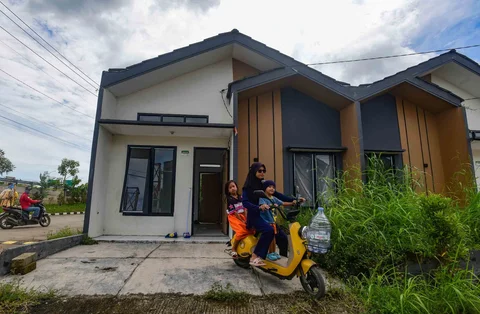 Warga mengendarai sepeda listrik di depan rumahnya pada Perumahan Subsidi Pondok Pengampelan Indah, Serang , Banten, Selasa (17/02/2026).