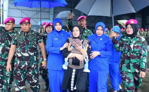 Panglima Korps Marinir Letnan Jenderal TNI (Mar) Endi Supardi bersama istri dan anak mendiang prajurit saat pelepasan jenazah dua prajurit Korps Marinir TNI Angkatan Laut korban musibah tanah longsor di Lanudal Pondok Cabe, Jakarta, Minggu (01/02/2026).