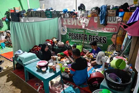 Sebuah keluarga berbuka puasa Ramadan di tempat penampungan sementara bagi korban banjir di Meurah Dua, distrik Pidie Jaya, Sabtu (21/02/2026).