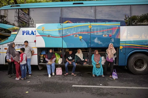 Warga berdatangan untuk menaiki bus gratis yang disediakan Pemprov Jawa Timur di Surabaya, Kamis (19/03/2026).