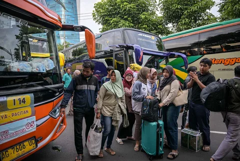 Warga berdatangan untuk menaiki bus gratis yang disediakan Pemprov Jawa Timur di Surabaya, Kamis (19/03/2026).