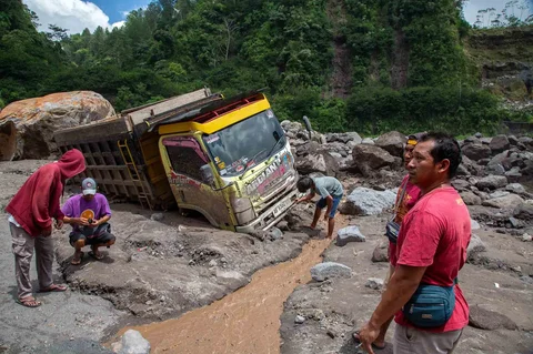 Warga  mengambil bagian truk yang terkubur di pasir setelah banjir lahar dingn  dari Gunung Merapi di Sungai Senowo di Magelang, Jawa Tengah, Rabu (04/03/20026).