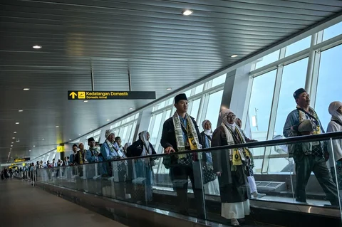 Para jemaah calon haji berjalan menuju gerbang keberangkatan pesawat di Terminal 1 Bandara Internasional Juanda Surabaya di Sidoarjo, Jawa Timur, Rabu (22/4/2026).
