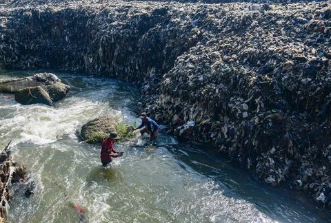 Warga mendulang benda-benda logam pada aliran Kali Pesanggrahan yang menyempit alibat longsoran timbunan sampah TPA Cipayung di kawasan Pasir Putih, Depok, Jawa Barat, Senin (27/04/2026).