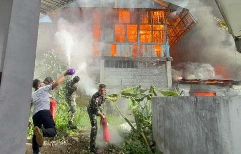Prajurit TNI Angkatan Laut dari Kodaeral VIII bersama petugas dan warga memadamkan kebakaran di permukiman Kelurahan Kairagi Weru, Kota Manado, Selasa (28/4/2026).