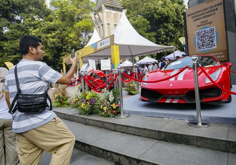 Warga menyaksikan barang mewah hasil rampasan Kejaksaan Agung pada acara rangkaian BPA Fair 2026 di Car Free Day (CFD) Jalan Sudirman, Jakarta, Minggu (10/05/2026).