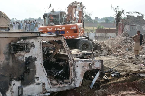 Ekskavator membersihkan puing-puing setelah serangan bom mobil oleh militan terhadap  pos pemeriksaan polisi di daerah Fateh Khel, Bannu, Pakistan, Miunggu (10/05/2026).